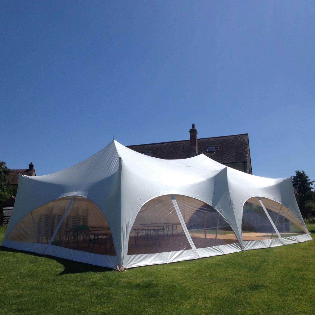White 28' x 38' Capri Tent with clear windows installed on grass 