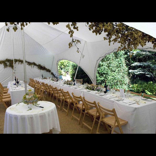 Interior of 28' x 38' Capri Tent showing furniture set up for a small intimate wedding